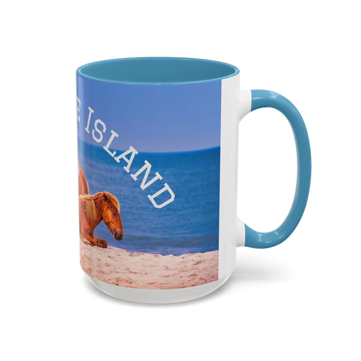 Ceramic coffee mug with wild horse on a beach scene, featuring blue accent handle and interior.